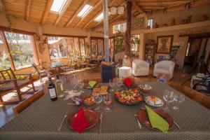 a dining room with a table with food and wine glasses at Solar del Tropico in Huacalera