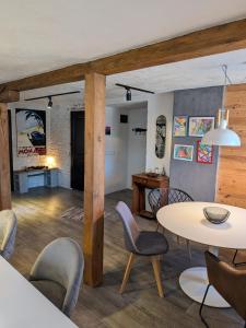 a living room with a table and chairs at Apartments 18 - Central & Cozy in Velingrad +40 photos