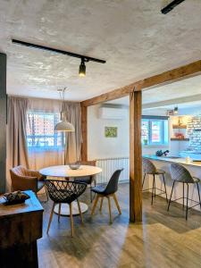 a dining room and kitchen with a table and chairs at Apartments 18 - Central & Cozy in Velingrad