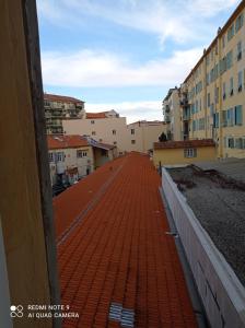 a red tile roof on a building with buildings at GautierNice in Nice