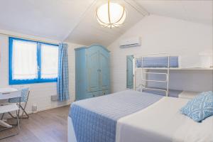 a bedroom with a bed and a blue cabinet at Camping Car Palmasera in Cala Gonone