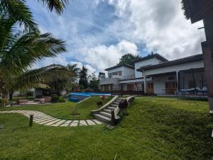 a yard with a house and a swimming pool at Villa HASSANI BEACH FOULPOINTE in Foulpointe