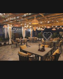 a dining room with tables and chairs and lights at Hotel Parth Inn in Haldwāni +11 photos