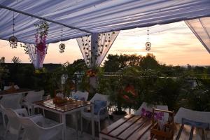 a patio with a table and chairs under a canopy at Hotel Parth Inn in Haldwāni