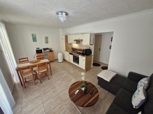 a living room with a couch and a table at Fenyves Ferienhaus 2 **** in Balatonfenyves