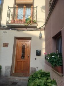 a wooden door on a building with a balcony at Valvanera 30 in Berceo