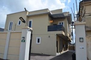 a white building with a gate in front of it at Starlight Homes in Asaba