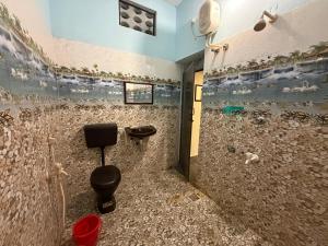 a bathroom with a shower with a toilet and a sink at Serinity Saral in Pondicherry