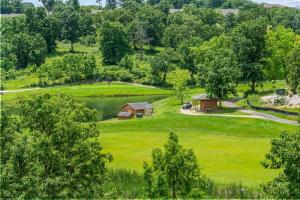 an aerial view of a golf course with a lake at Green Mountain Getaway 2BDR in Branson