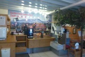 a coffee shop with a sign on the wall at Smart Motel eU in Strass im Attergau
