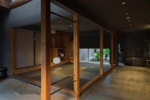 a room with glass doors and a room with a plant at MU HEN KO Q -Nara- in Nara