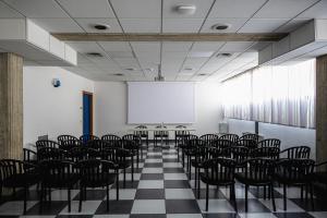 a room with a table and chairs in it at Hotel Cavallino in Faenza