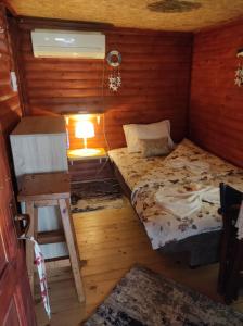 a small room with a bed and a stool in it at Vanilla House in Ulcinj
