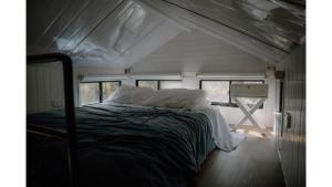 a bed in the middle of a tiny house at Banyula Cove by Tiny Away in Barnes Bay