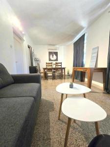 a living room with a couch and tables and a piano at Garden House Tučepi in Tučepi