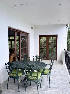 a table and chairs sitting on a patio at Private Retreat in Gordonʼs Bay