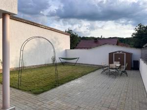 a patio with a table and a swing at Casa Happy in Petroşani