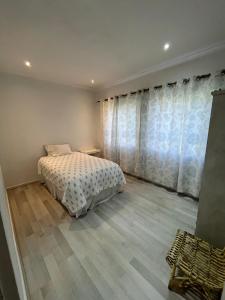 a bedroom with a bed and a large window at Private Retreat in Gordonʼs Bay +11 photos