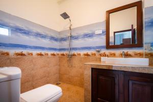 a bathroom with a toilet and a sink and a mirror at Ella Blue Heaven in Ella +34 photos