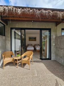 a patio with two chairs and a table and a bed at Bali View Ubud Hotel in Ubud +52 photos