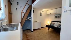 a kitchen with a sink and a staircase in a room at Il noce - case vacanza- in Sestri Levante