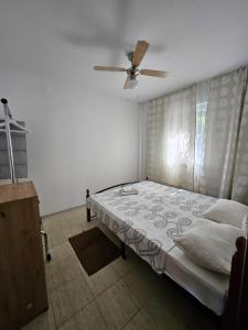 a bedroom with a bed and a ceiling fan at Gabi 1 in Ðuraševići