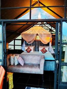 a room with a couch and an umbrella at Lemon Valley Farm in Elmenteita +92 photos