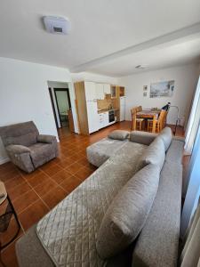 a living room with a couch and chairs and a table at Gabi 1 in Ðuraševići