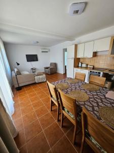 a kitchen and dining room with a table and chairs at Gabi 1 in Ðuraševići