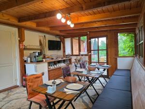 a dining room with tables and chairs in a cabin at Susann Vendégház in Szigetmonostor
