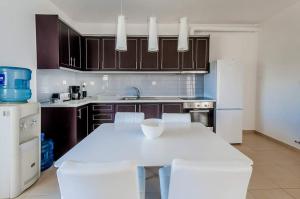 a kitchen with a white table and white appliances at Paliouri Villas in Paliouri