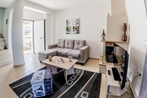 a living room with a couch and a table at Paliouri Villas in Paliouri