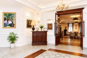 a living room with a door leading to a dining room at Dhavara Boutique Hotel in Vientiane