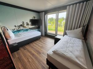 a hotel room with two beds and a window at CBS Hotel by WMM Hotels in Cottbus
