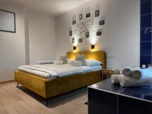 a bedroom with a large bed and a table at L69 Apartments - Angel's Apartment in Banská Bystrica +5 photos
