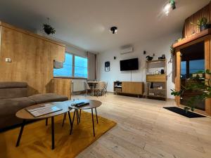 a living room with a couch and a table at L69 Apartments - Angel's Apartment in Banská Bystrica