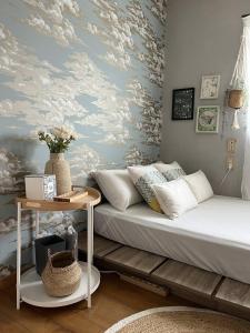a living room with a bed and a table at 青梅駅3分OME桜梅庵omean tinyhouse designers hideaway in Ome