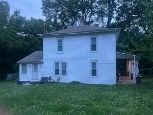 a white house in a field of green grass at Tranquil Retreat-Off the Beaten Path in Independence