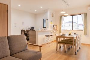 a living room and kitchen with a table and chairs at Fujiyama Stay101 in Fujinomiya