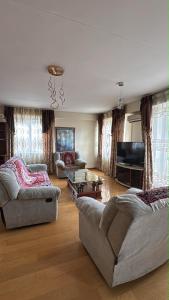 a living room with two couches and a television at Near ASA Arena Circus in Ulaanbaatar