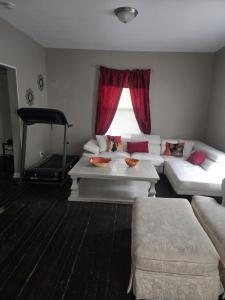 a living room with white couches and a window at Tranquil Retreat-Off the Beaten Path in Independence