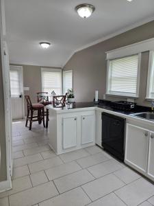 a kitchen with white cabinets and a table and chairs at Tranquil Retreat-Off the Beaten Path in Independence