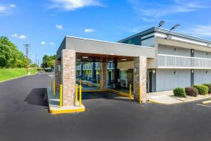 a building with a parking lot in front of it at Quality Inn Concord Kannapolis in Concord