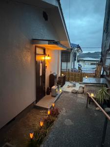 a house with a porch with lights on it at 青梅駅3分OME桜梅庵omean tinyhouse designers hideaway in Ome