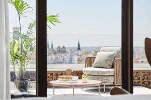 a living room with a chair and a coffee table at Thompson Madrid, by Hyatt in Madrid