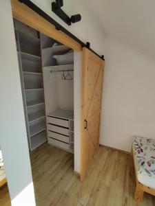 a room with a closet with a sliding door at Apartament Karmelicka in Wadowice