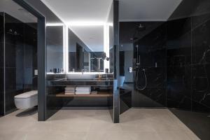 a bathroom with a sink and a toilet and a mirror at Buff Medical Resort Konstanz in Konstanz +36 photos