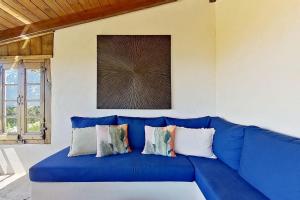 a blue couch sitting in a living room at La Lézardière - Suites de Prestige & Spas Privatifs in Porto-Vecchio