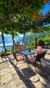 a table and chairs sitting under a tree at Apartment Capt Seferovic in Donji Morinj