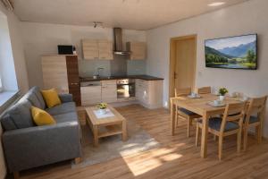 a living room with a couch and a table at Ferienwohnungen Gutenbrunn in Gutenbrunn